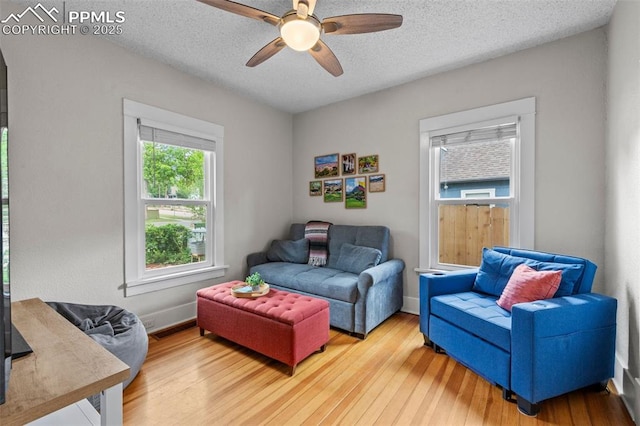 421 N Spruce St, Colorado Springs, CO 80905 - living area with a ceiling fan, hardwood / wood-style flooring, a textured ceiling, and baseboards
