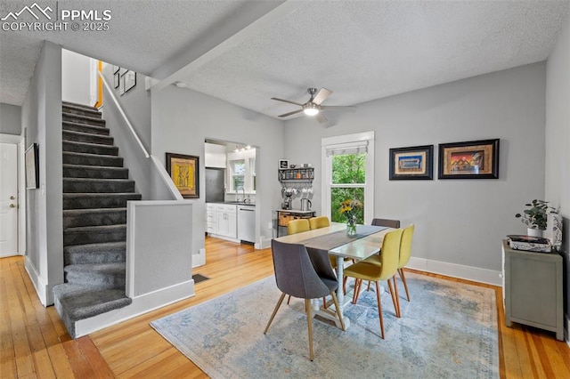 421 N Spruce St, Colorado Springs, CO 80905 - dining room featuring a textured ceiling, stairs, light wood-style floors, a ceiling fan, and baseboards