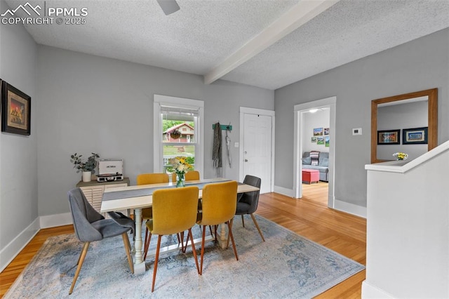 421 N Spruce St, Colorado Springs, CO 80905 - dining room featuring beam ceiling, wood finished floors, a textured ceiling, and baseboards