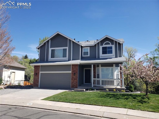 1185 Marlstone Pl, Colorado Springs, CO 80904 - traditional-style home featuring covered porch, an attached garage, driveway, a front yard, and brick siding