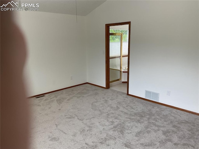 1185 Marlstone Pl, Colorado Springs, CO 80904 - carpeted spare room featuring baseboards and lofted ceiling