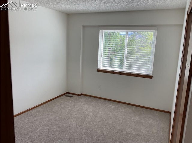 1185 Marlstone Pl, Colorado Springs, CO 80904 - carpeted empty room featuring a textured ceiling and baseboards