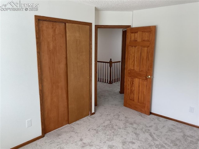 1185 Marlstone Pl, Colorado Springs, CO 80904 - unfurnished bedroom featuring carpet flooring, a closet, and a textured ceiling
