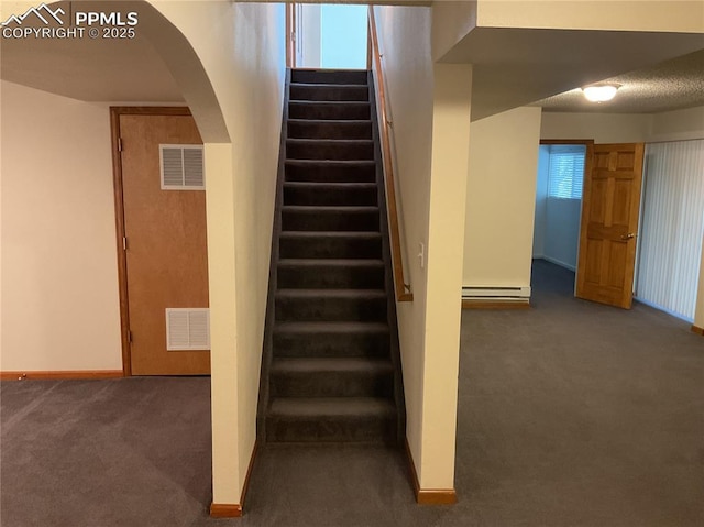1185 Marlstone Pl, Colorado Springs, CO 80904 - stairway with arched walkways, carpet, and a baseboard heating unit