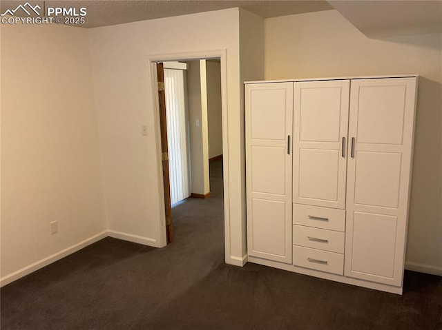 1185 Marlstone Pl, Colorado Springs, CO 80904 - unfurnished bedroom with dark colored carpet and a closet