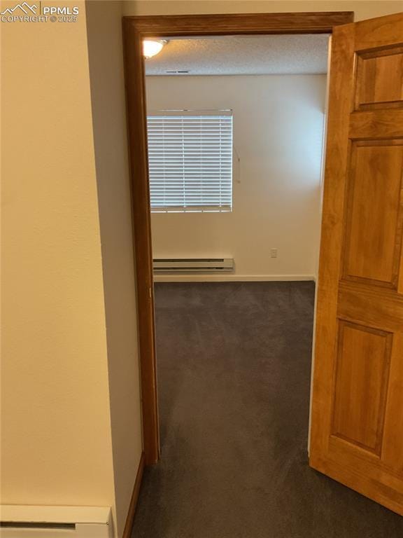 1185 Marlstone Pl, Colorado Springs, CO 80904 - hall with baseboard heating and dark colored carpet