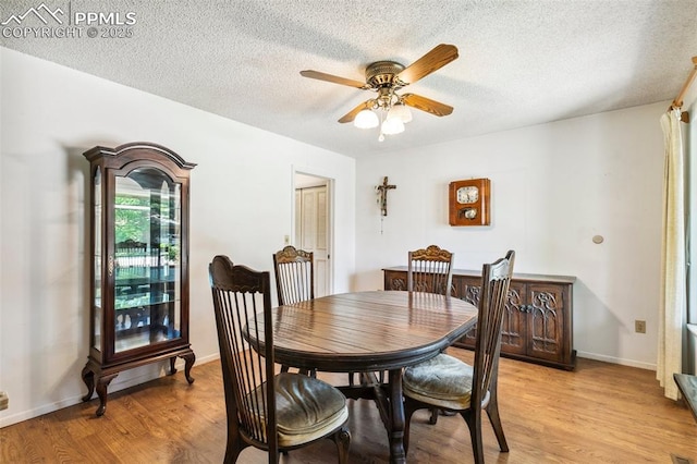 965 Red Mesa Dr, Colorado Springs, CO 80906 - dining room featuring ceiling fan, light wood-style floors, and a textured ceiling