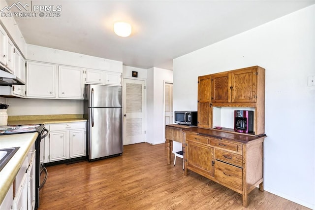 965 Red Mesa Dr, Colorado Springs, CO 80906 - kitchen featuring stainless steel appliances, wood finished floors, white cabinets, and light countertops