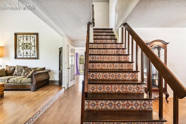 965 Red Mesa Dr, Colorado Springs, CO 80906 - staircase with a textured ceiling and wood finished floors