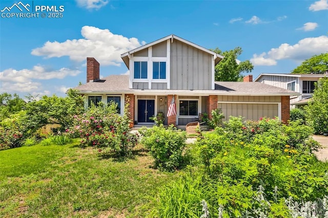 965 Red Mesa Dr, Colorado Springs, CO 80906 - traditional home with a chimney, board and batten siding, a garage, brick siding, and a front yard