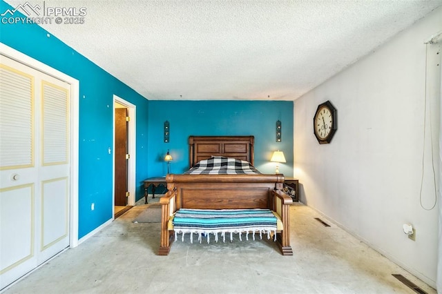 965 Red Mesa Dr, Colorado Springs, CO 80906 - bedroom featuring a textured ceiling, unfinished concrete floors, and a closet