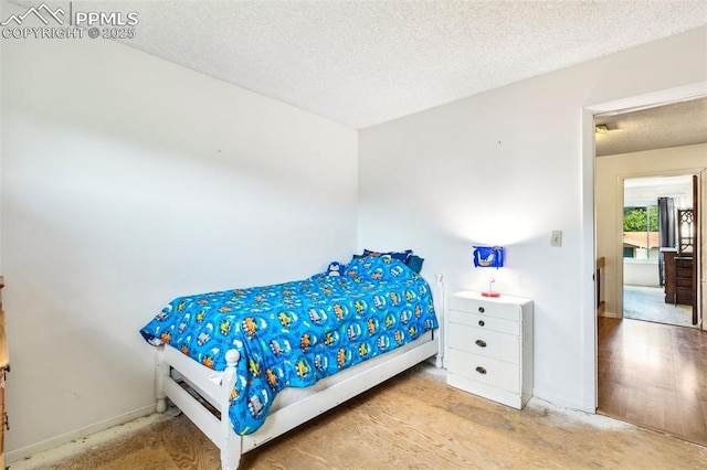 965 Red Mesa Dr, Colorado Springs, CO 80906 - bedroom with a textured ceiling and light wood finished floors