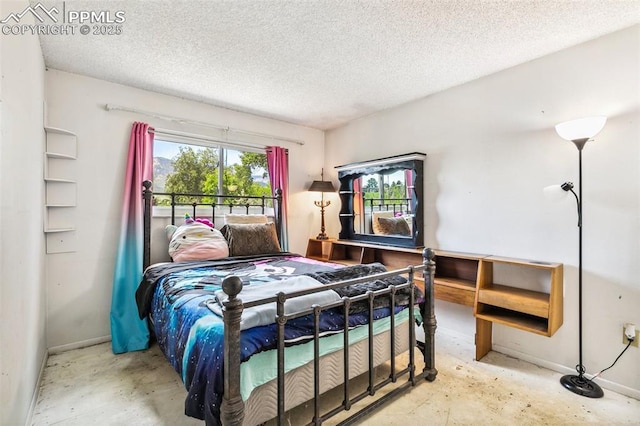 965 Red Mesa Dr, Colorado Springs, CO 80906 - bedroom featuring concrete floors and a textured ceiling