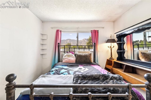 965 Red Mesa Dr, Colorado Springs, CO 80906 - bedroom featuring a textured ceiling and a mountain view