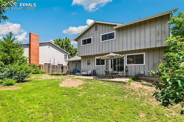 965 Red Mesa Dr, Colorado Springs, CO 80906 - back of property with board and batten siding and a patio