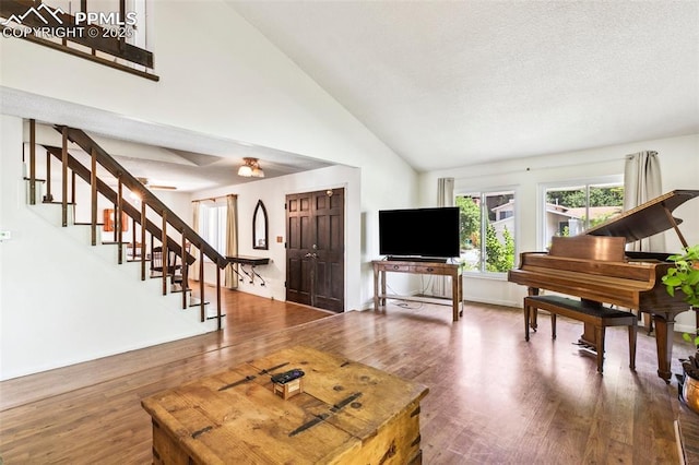 965 Red Mesa Dr, Colorado Springs, CO 80906 - living room with stairway, wood finished floors, and high vaulted ceiling