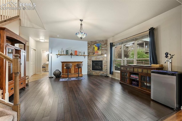 2374 Cinnabar Rd, Colorado Springs, CO 80921 - living area with stairway, hardwood / wood-style floors, and a stone fireplace
