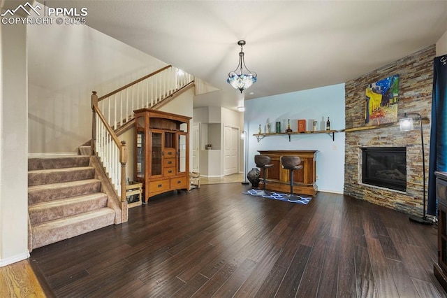 2374 Cinnabar Rd, Colorado Springs, CO 80921 - living area featuring wood finished floors, stairway, and a fireplace