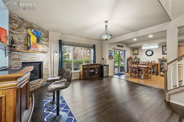 2374 Cinnabar Rd, Colorado Springs, CO 80921 - living area with a fireplace, stairway, wood finished floors, and recessed lighting