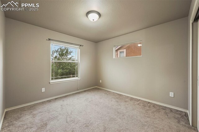 2374 Cinnabar Rd, Colorado Springs, CO 80921 - carpeted spare room featuring baseboards and a textured ceiling