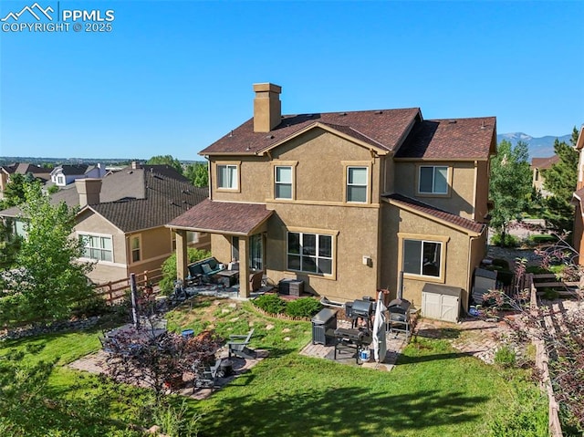 2374 Cinnabar Rd, Colorado Springs, CO 80921 - back of house featuring stucco siding, a patio, and a chimney