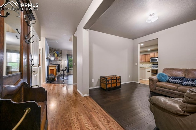 2374 Cinnabar Rd, Colorado Springs, CO 80921 - living area featuring dark wood-style flooring and a stone fireplace