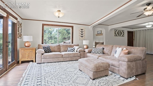 145 Valley Ln, Woodland Park, CO 80863 - living area with plenty of natural light, wood finished floors, ceiling fan, arched walkways, and ornamental molding