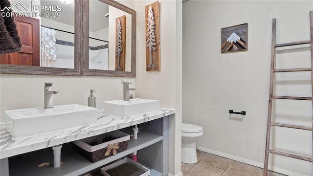 145 Valley Ln, Woodland Park, CO 80863 - bathroom with toilet, tile patterned flooring, baseboards, and double vanity