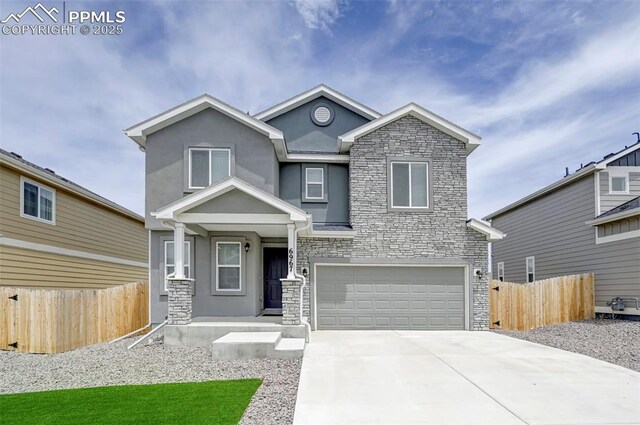 6967 Akela Ln, Colorado Springs, CO 80925 - view of front of home featuring stone siding, an attached garage, stucco siding, and driveway