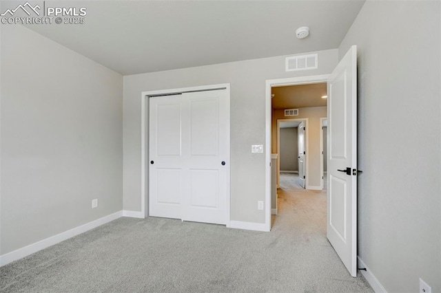 6967 Akela Ln, Colorado Springs, CO 80925 - unfurnished bedroom with baseboards, light carpet, and a closet