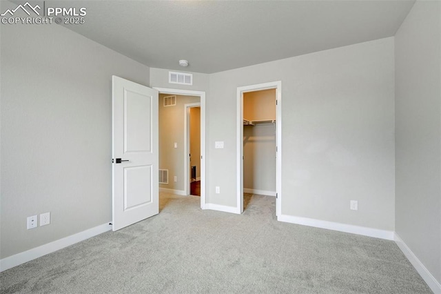 6967 Akela Ln, Colorado Springs, CO 80925 - unfurnished bedroom with carpet floors, a spacious closet, and baseboards