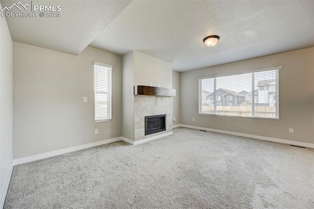 6967 Akela Ln, Colorado Springs, CO 80925 - unfurnished living room with a textured ceiling, healthy amount of natural light, and baseboards