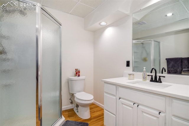 16084 Stonebriar Dr, Parker, CO 80134 - full bath featuring wood finished floors, vanity, a stall shower, toilet, and baseboards