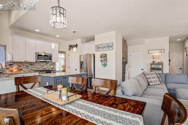 16084 Stonebriar Dr, Parker, CO 80134 - living room featuring a chandelier, recessed lighting, and dark wood-style floors