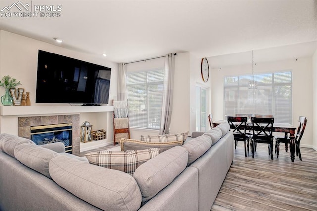16084 Stonebriar Dr, Parker, CO 80134 - living area featuring wood finished floors, a tile fireplace, a chandelier, and recessed lighting