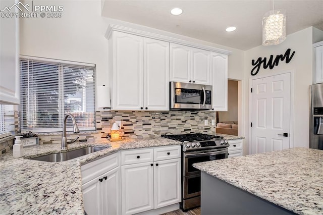 16084 Stonebriar Dr, Parker, CO 80134 - kitchen featuring appliances with stainless steel finishes, a sink, white cabinetry, decorative backsplash, and recessed lighting