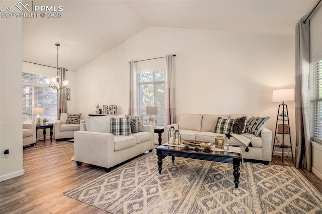 16084 Stonebriar Dr, Parker, CO 80134 - living room featuring a chandelier, vaulted ceiling, wood finished floors, plenty of natural light, and baseboards