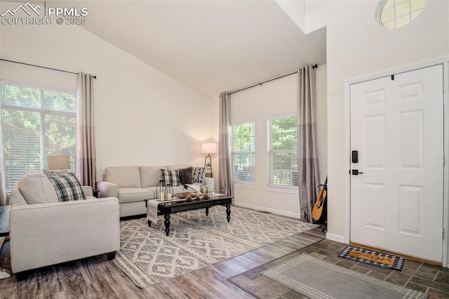 16084 Stonebriar Dr, Parker, CO 80134 - living area featuring vaulted ceiling, healthy amount of natural light, and baseboards