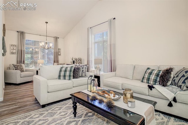 16084 Stonebriar Dr, Parker, CO 80134 - living room with a chandelier, lofted ceiling, healthy amount of natural light, and wood finished floors