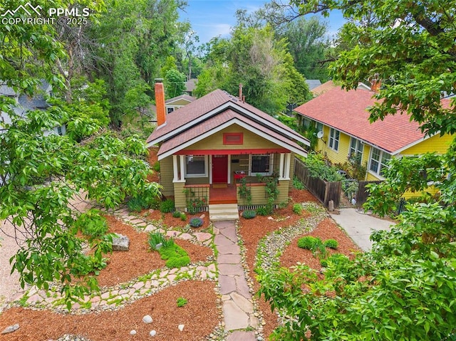 424 N Cedar St, Colorado Springs, CO 80903 - view of front facade featuring a porch and a chimney