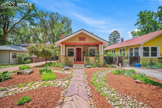 424 N Cedar St, Colorado Springs, CO 80903 - view of front facade featuring covered porch and a chimney