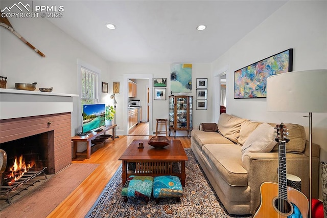 424 N Cedar St, Colorado Springs, CO 80903 - living room featuring light wood-style flooring, recessed lighting, and a brick fireplace