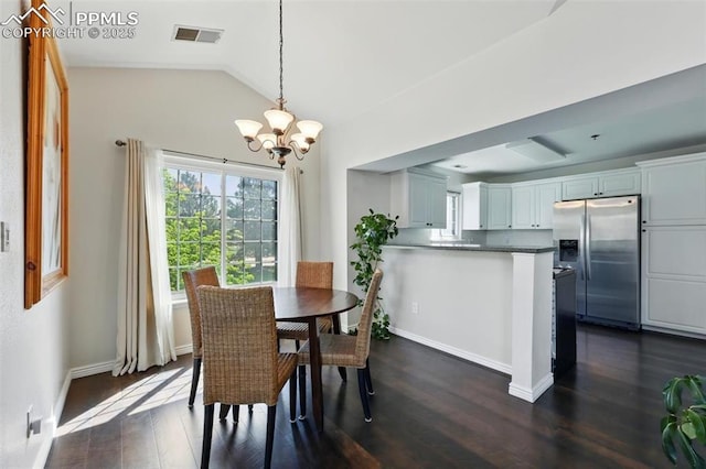 2150 Alicia Pt Unit 201, Colorado Springs, CO 80919 - dining room with a chandelier, dark wood-type flooring, vaulted ceiling, and baseboards