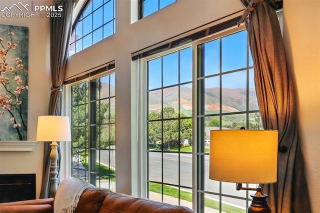 2150 Alicia Pt Unit 201, Colorado Springs, CO 80919 - doorway featuring a towering ceiling, a fireplace, and a mountain view