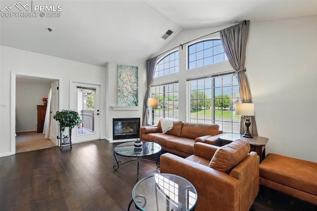 2150 Alicia Pt Unit 201, Colorado Springs, CO 80919 - living room with wood finished floors, a fireplace with flush hearth, vaulted ceiling, and baseboards