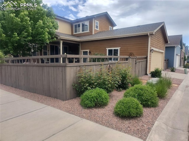 1593 Gold Hill Mesa Dr, Colorado Springs, CO 80905 - view of property exterior featuring an attached garage, a shingled roof, and concrete driveway
