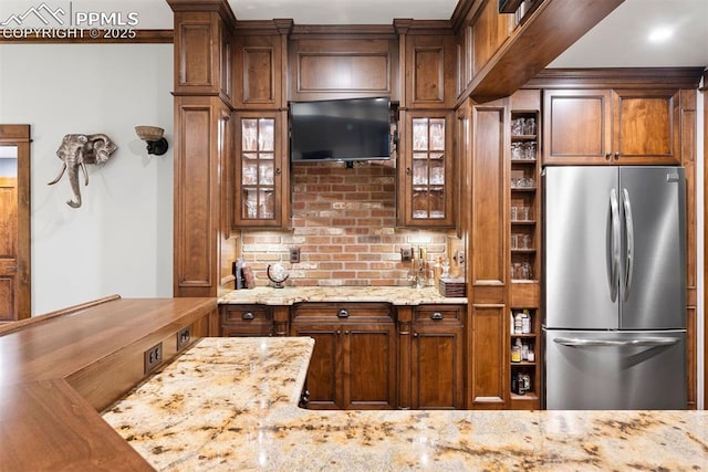 3 Mesa Ln, Colorado Springs, CO 80906 - kitchen with freestanding refrigerator, light stone counters, and glass insert cabinets