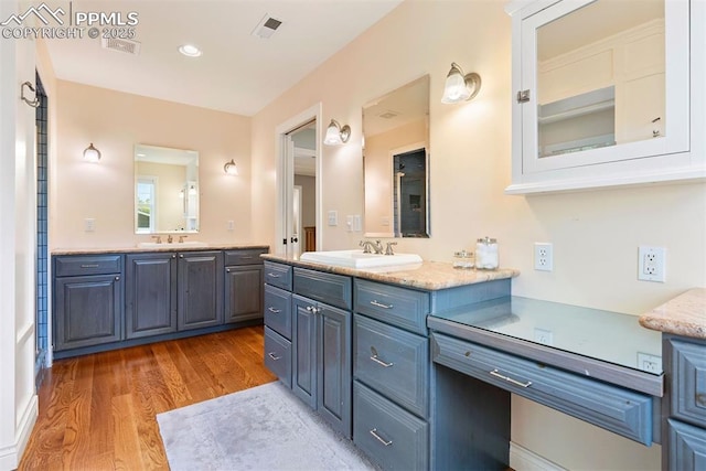 3 Mesa Ln, Colorado Springs, CO 80906 - bathroom featuring two vanities, wood finished floors, and recessed lighting