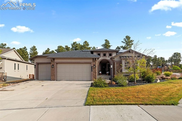 1734 Summerglow Ln, Monument, CO 80132 - view of front of house featuring stucco siding, an attached garage, concrete driveway, and a front yard