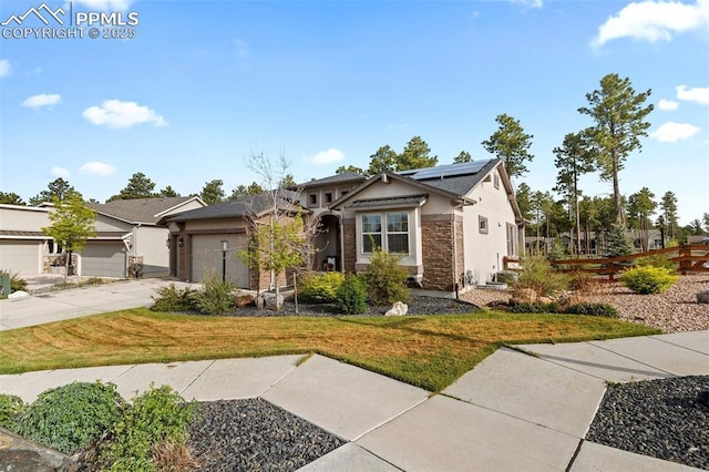 1734 Summerglow Ln, Monument, CO 80132 - craftsman-style home with solar panels, concrete driveway, a front lawn, and an attached garage